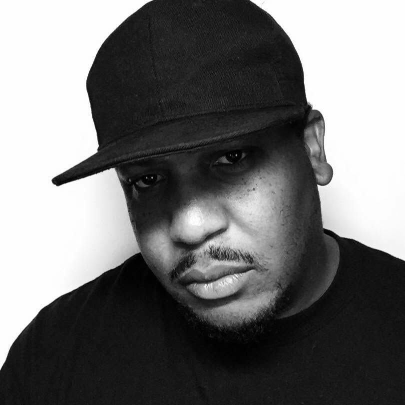 Black-and-white portrait of Vince Wiley wearing a hat